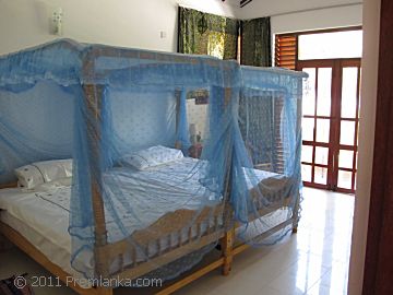 Premlanka Hotel, Bedroom with twin canopy beds.
